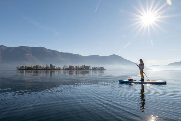istock Woman paddling on a stand up paddle board 1355433179
