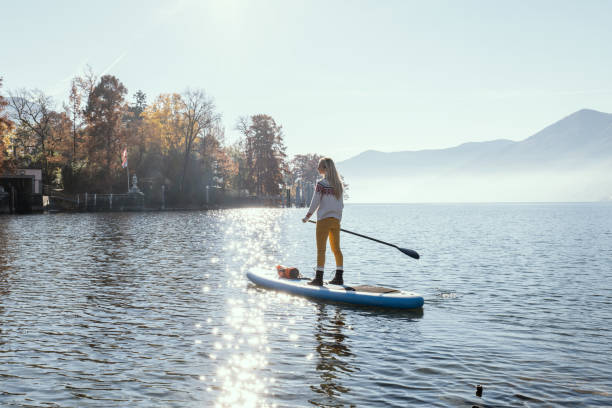 istock Woman paddling on a stand up paddle board 1355433203