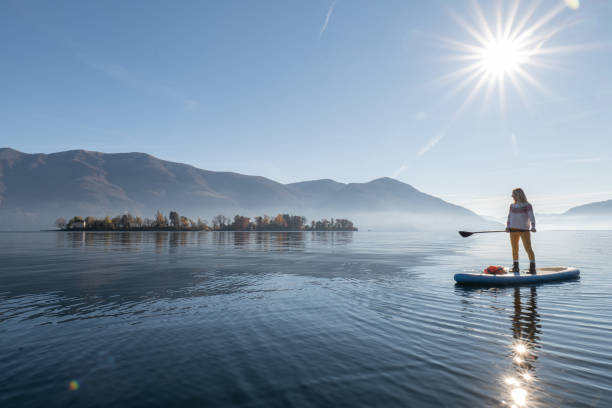 istock Woman paddling on a stand up paddle board 1355433209