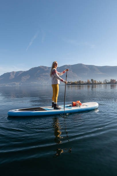 istock Woman paddling on a stand up paddle board 1355433253