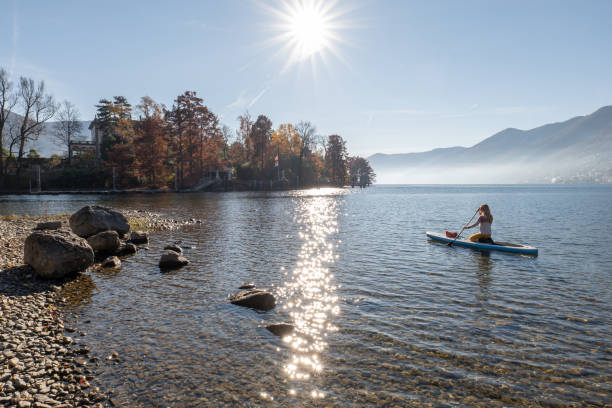 istock Woman paddling on a stand up paddle board 1355433266