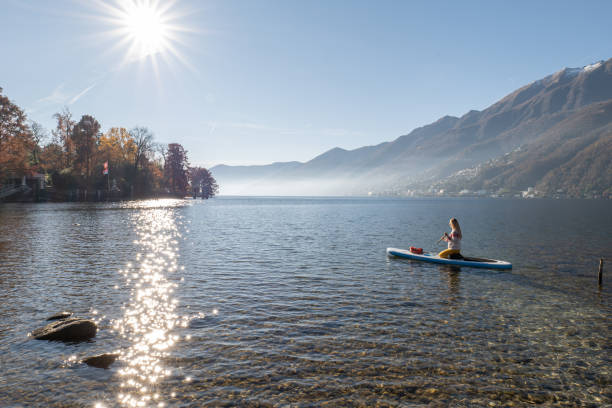 istock Woman paddling on a stand up paddle board 1355433286