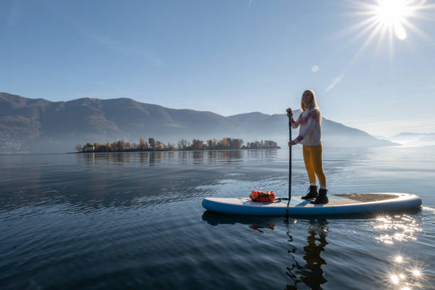 istock Woman paddling on a stand up paddle board 1355433301