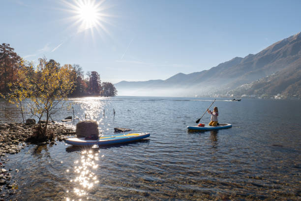 istock Woman paddling on a stand up paddle board 1355433347