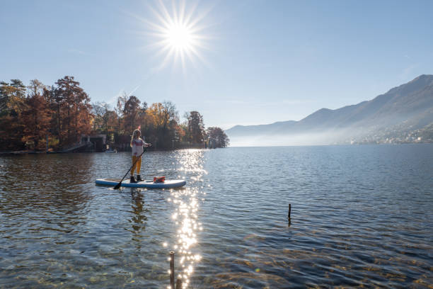 istock Woman paddling on a stand up paddle board 1355433348