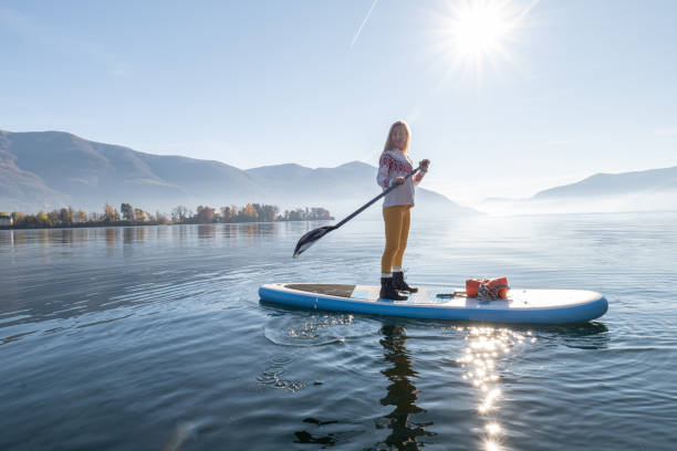 istock Woman paddling on a stand up paddle board 1355433508