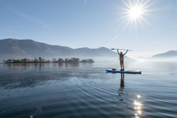 istock Woman paddling on a stand up paddle board 1355433538
