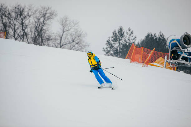 istock woman skier at ski slope 1355434376