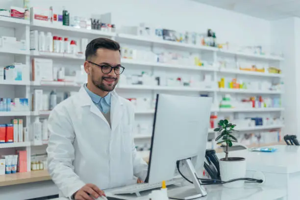 Photo of Portrait of a handsome pharmacist working in a pharmacy