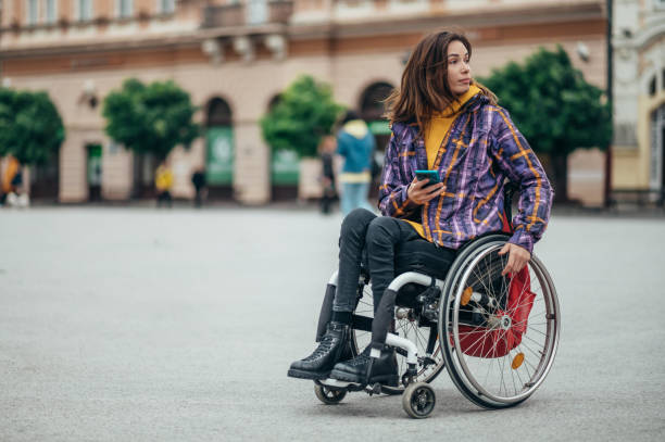 istock Woman with disability using a smartphone while out in the city 1355434751