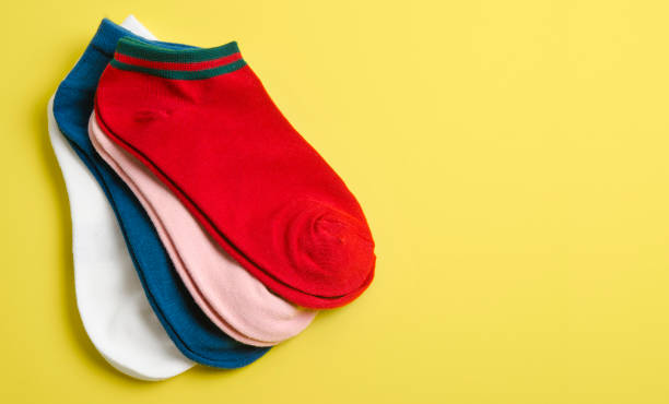 istock Many socks on a yellow background and space 1355440147