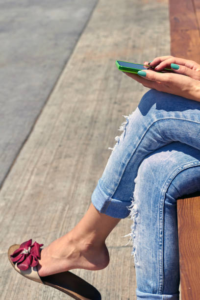 istock Female using modern smartphone outdoors. 1355441374