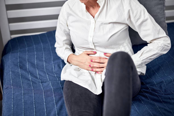 Woman with strong stomach pain at home. Woman with strong stomach pain at home. polycystic ovary syndrome photos stock pictures, royalty-free photos & images