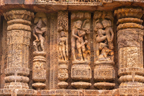 Temple platform of Jagamohana carved with  erotic couples, young women flaunting their beauty in poses, nagas, vyalas, soldiers, elephants, court scenes and from daily life. Sun Temple Konark, Odisha, India. Temple platform of Jagamohana carved with  erotic couples, young women flaunting their beauty in poses, nagas, vyalas, soldiers, elephants, court scenes and from daily life. Sun Temple Konark, Odisha, India. chariot wheel at konark sun temple india stock pictures, royalty-free photos & images