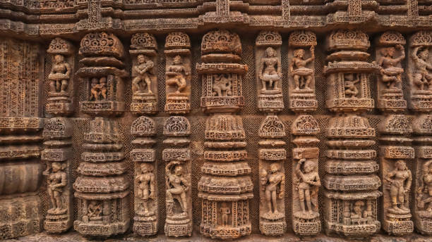 Carvings of  musicians and dancers that almost completely cover the platform, walls and pillars of the hall on Bhoga Mandapa or the dance hall, Sun Temple, Konark, India. Carvings of  musicians and dancers that almost completely cover the platform, walls and pillars of the hall on Bhoga Mandapa or the dance hall, Sun Temple, Konark, India. chariot wheel at konark sun temple india stock pictures, royalty-free photos & images