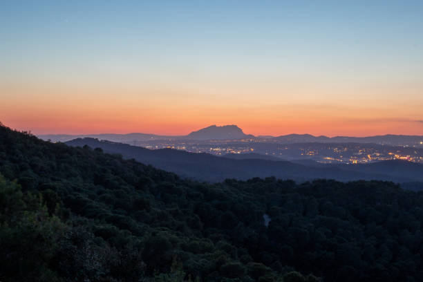 istock Montserrat mountain viewed from far after the sunset 1355442882