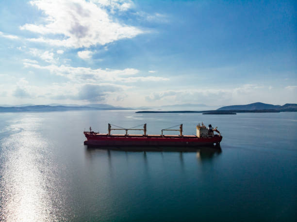 istock Aerial View Cargo Ship Waiting to Enter the Port 1355445735