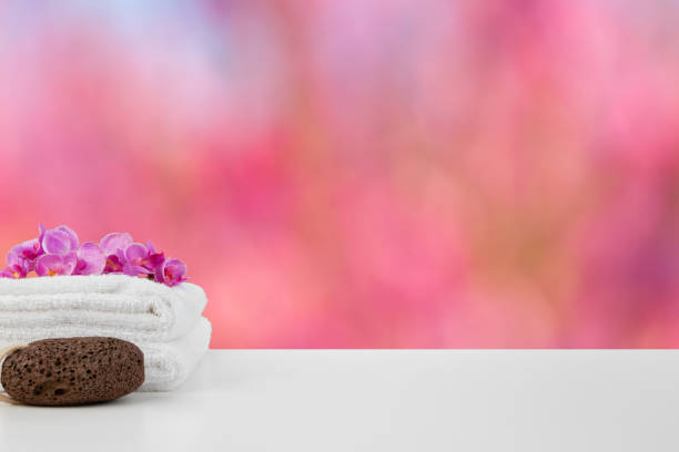 istock Towels with flowers on light table against blurred background 1355447765