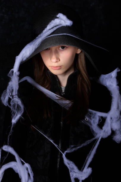 funny child girl in witch costume for Halloween with pumpkin Jack isolated on white background