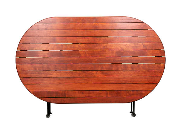 Round wooden table with folded metal legs on a white background.