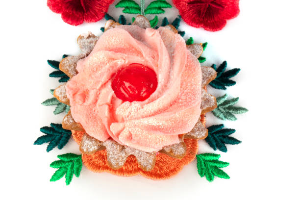 istock Beautiful cake on a bright floral fabric isolated on a white background. 1355450407