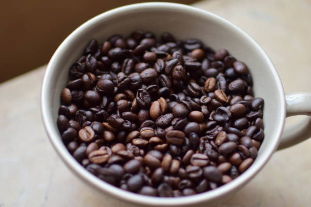 istock Roasted coffee beans in a cup as a close up 1355455697