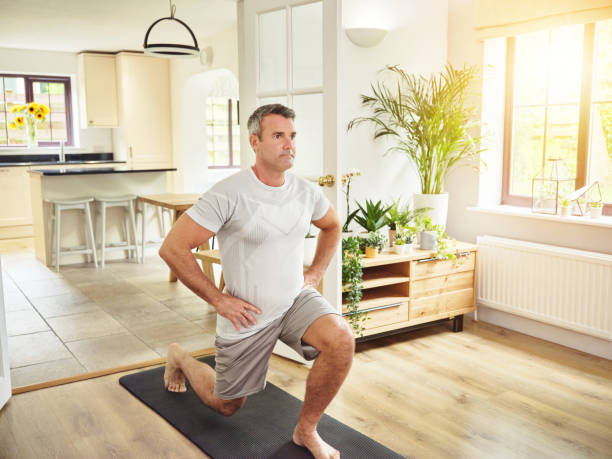 istock Shot of a mature man doing lunges at home 1355457836