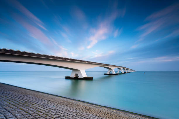 Zeelandbrug (Zeeland Bridge) in the Dutch province of Zeeland in the morning against a blue sky stock photo