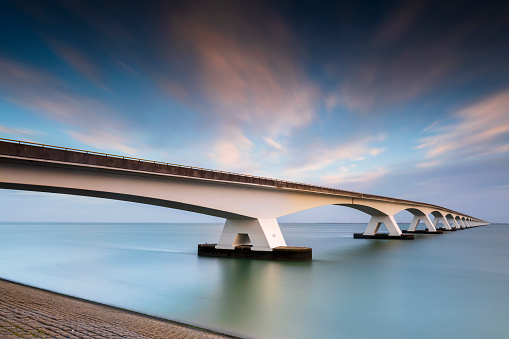 Zeelandbrug (Zeeland Bridge) in the Dutch province of Zeeland, the longest bridge of the Netherlands,  in the morning against a blue sky