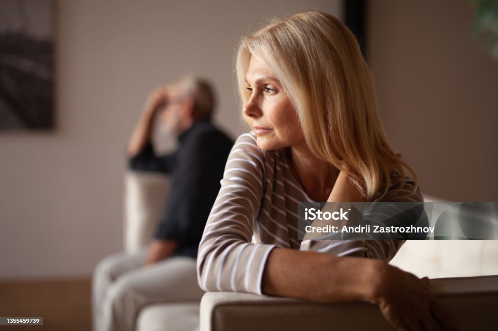 The older couple has a conflict. Upset mature woman, quarrel with her husband. Relationship crisis The older couple has a conflict. Upset mature woman, quarrel with her husband. Relationship crisis. Divorce Stock Photo