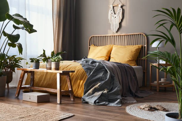 Stylish composition of bedroom interior with wooden bed, furniture and elegant accessories. Cozy home decor. stock photo
