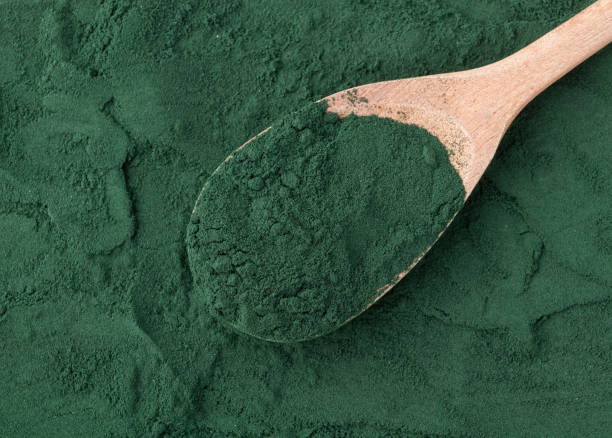 istock Spirulina algae powder in a spoon over wooden table 1355461839