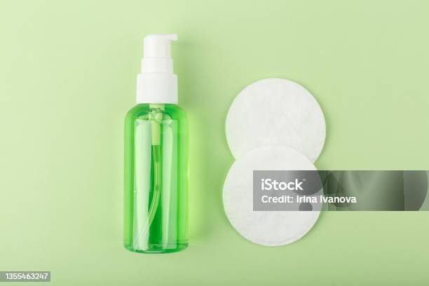 Top View Of Green Cleansing Foam Or Gel For Make Up Removing And Cotton Pads On Bright Green Background Stock Photo - Download Image Now