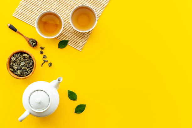 istock Ceramic white teapot and black tea in two cups, top view 1355463966