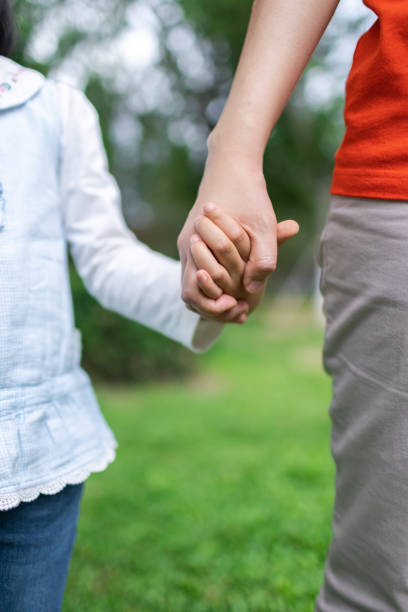 istock Daughter and mother's holding hands 1355466953