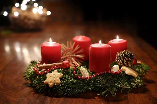 Christmas background with fir tree cones and red holly berries border frame on rustic wood and snow copy space with real natural fir branches and holly