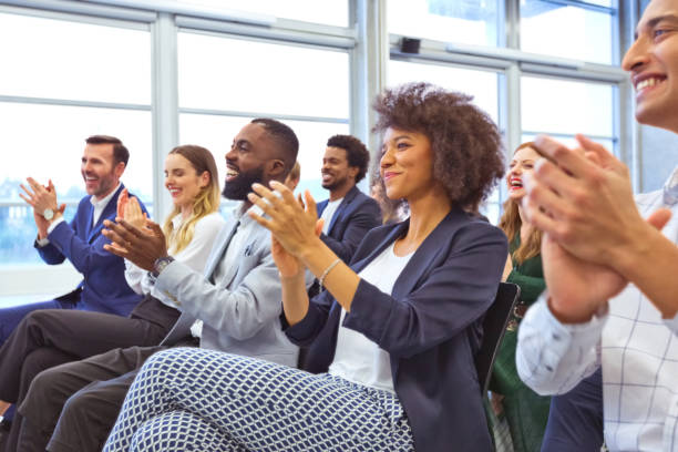 istock Cheerful audience during business seminar 1355471497