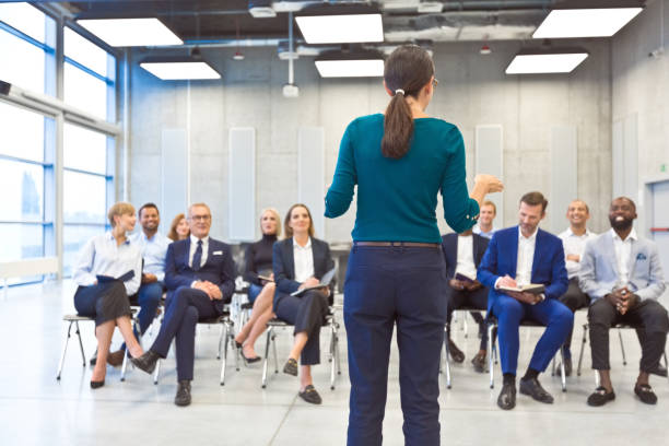 istock Woman speaking during business conference 1355472198