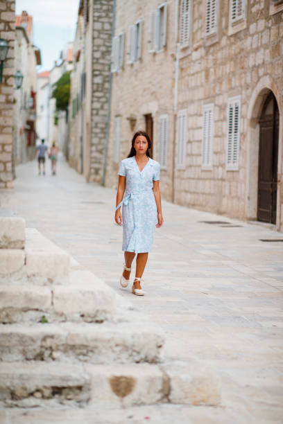 istock Beautiful brunette walking around an old town in Dalmatia 1355472774