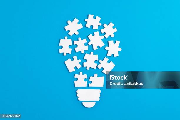 Idea Light Bulb Puzzle On Blue Background Stock Photo - Download Image Now - Inspiration, Ideas, Puzzle