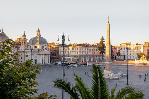 Cityscape of Piazza del Popolo, famous city square in Rome. Morning view on sunny weather. Flaminio obelisk and Santa Maria churches. Traveling Italy