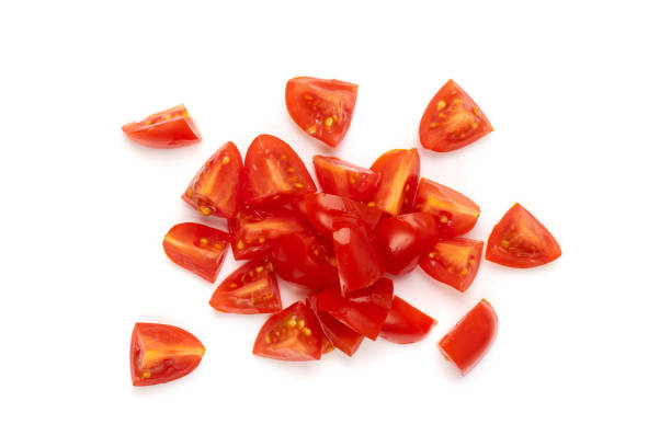 Long Plum Tomato Group Isolated, Fresh Small Cherry Tomatoes Diced plum tomato group isolated. Fresh small cherry tomatoes pieces, sliced cocktail tomate on white background top view tomato stock pictures, royalty-free photos & images