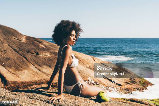 A black girl sitting on a beach