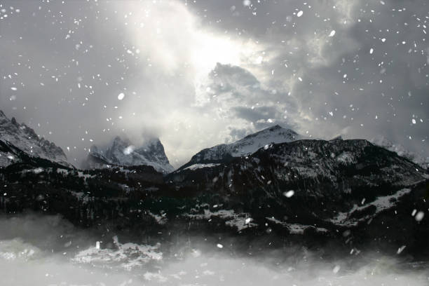 istock intense mood mountain range in switzerland alps, strong clouds and bright light at midday 1355475597