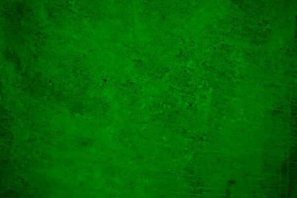 istock Green grunge background. Concrete wall. Toned cement surface texture. Rough background 1355475783