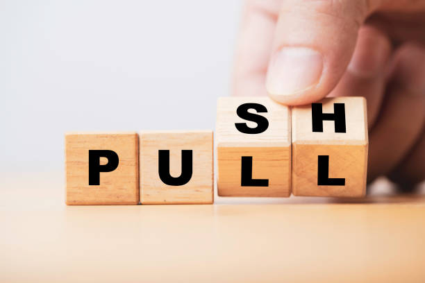 istock Hand flipping wooden cube block to change push and pull for business strategy and customer marketing concept. 1355477331
