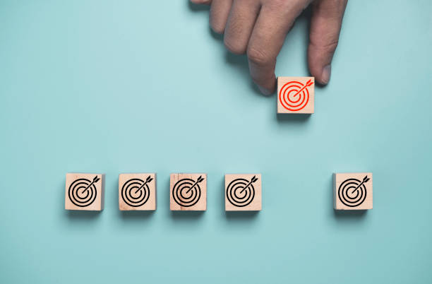 istock Hand move out and enhance red target board from black target board on blue background for increasing business goal and achievements concept. 1355477520