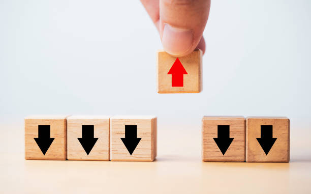 istock Hand holding increasing red arrow which move out and opposite way from black decreasing arrow for business and technology disruption concept. 1355477571