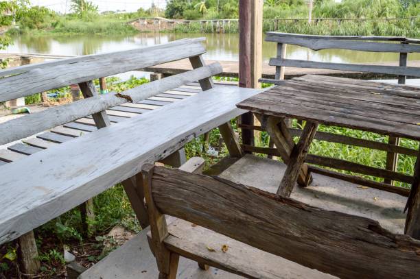 istock wooden bench and table in nature garden 1355480208