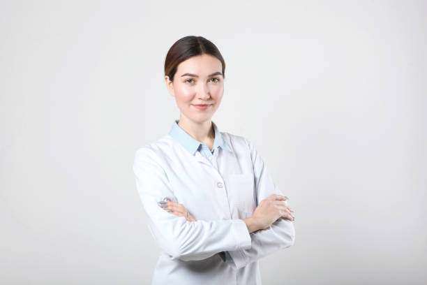 istock Young woman doctor on light background close-up 1355480560